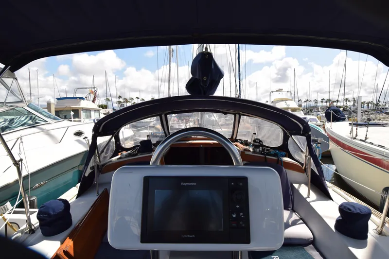 Slide: The Image of Cockpit view of a 1989 Catalina 36 sailboat docked at a marina. - 32