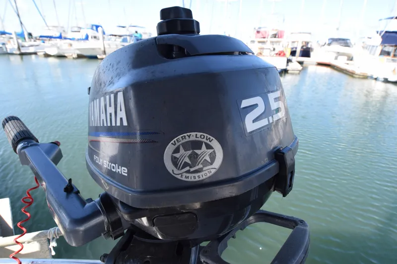 Slide: The Image of Yamaha 2.5 horsepower outboard motor on a 1989 Catalina 36 sailboat in a marina. - 35