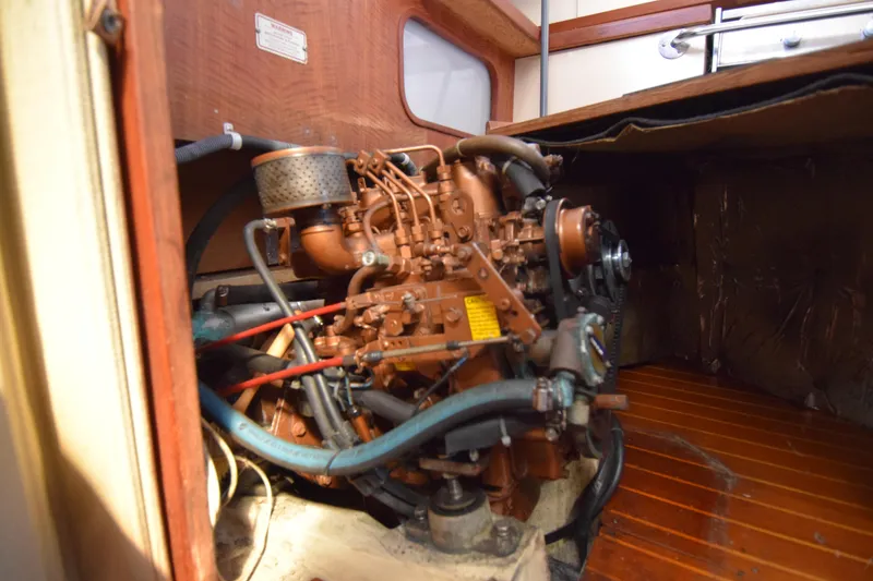 Slide: The Image of Engine compartment of a 1989 Catalina 36 sailboat, showcasing detailed mechanical components. - 36