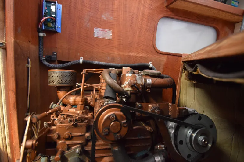 Slide: The Image of Engine compartment of a 1989 Catalina 36 sailboat, showcasing mechanical components. - 37