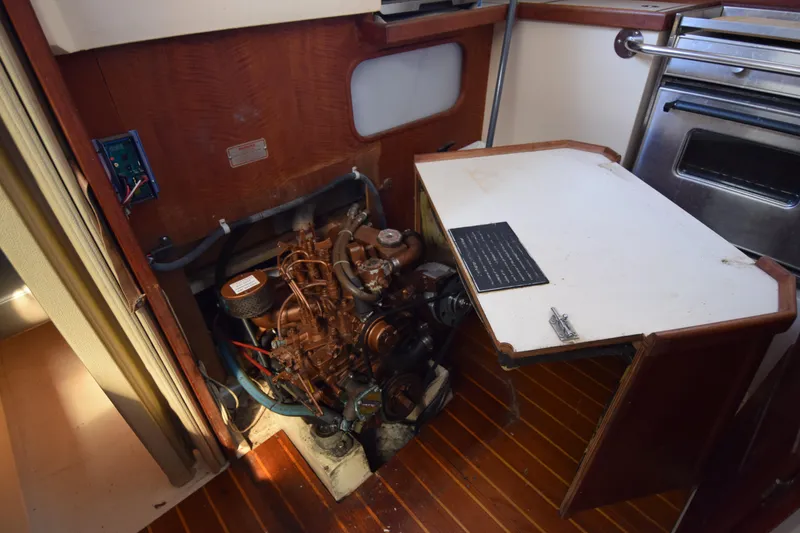 Slide: The Image of Engine compartment of a 1989 Catalina 36 sailboat, featuring a compact marine engine. - 38