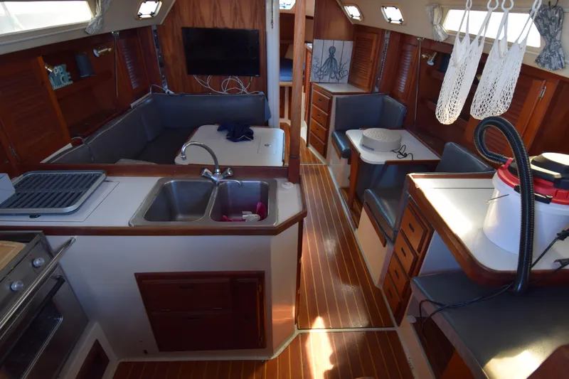 Slide: The Image of Interior of a 1989 Catalina 36 sailboat with kitchen and seating area. - 5