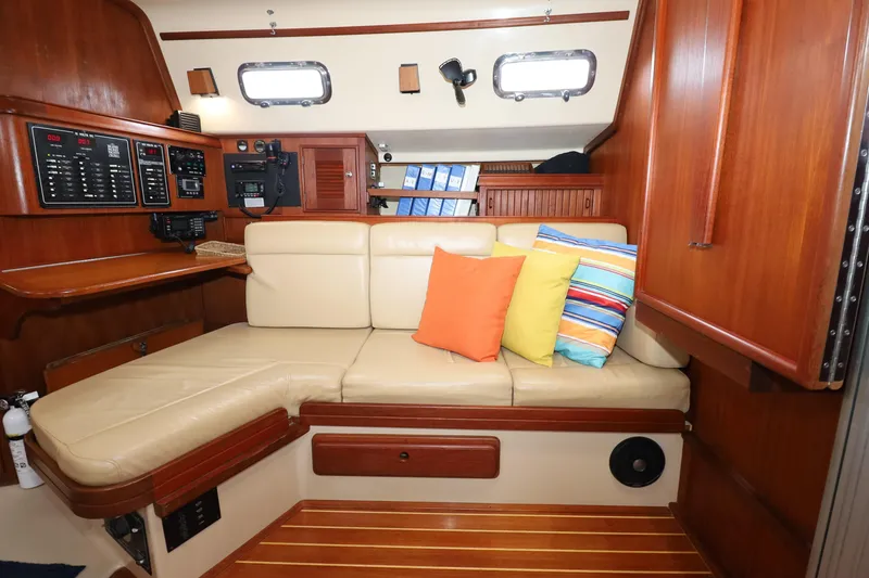 Slide: The Image of Interior of 2001 Island Packet 380 yacht with beige seating and colorful cushions. - 10