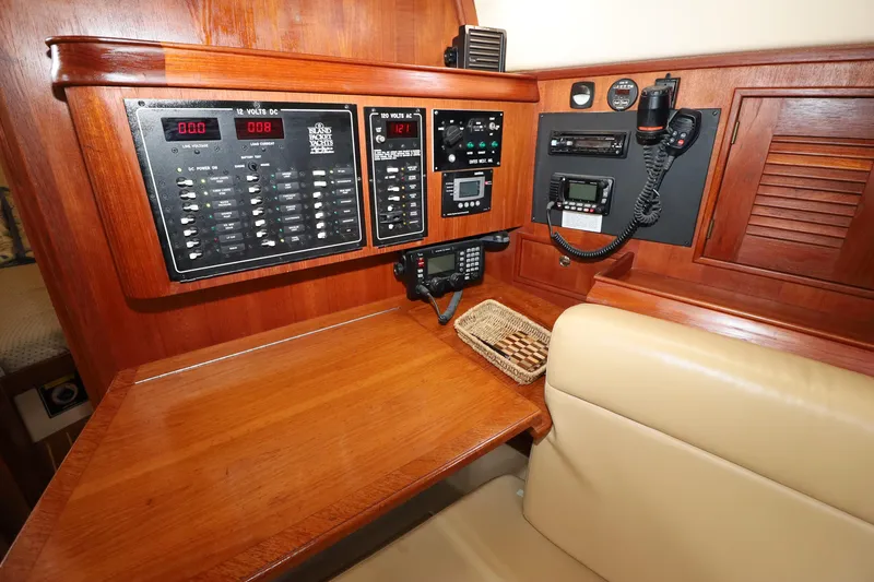 Slide: The Image of Navigation station of 2001 Island Packet 380 yacht with control panels and communication equipment. - 11