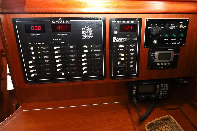 Slide: The Image of Electrical control panel of a 2001 Island Packet 380 yacht, featuring DC and AC systems. - 12