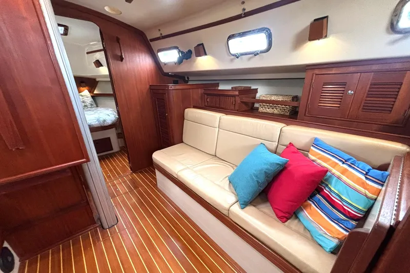 Slide: The Image of Interior of 2001 Island Packet 380 sailboat with cozy seating and colorful cushions. - 13