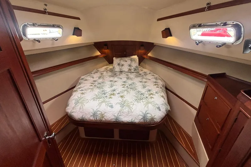 Slide: The Image of Cozy cabin interior of 2001 Island Packet 380 sailboat with tropical bedding. - 14