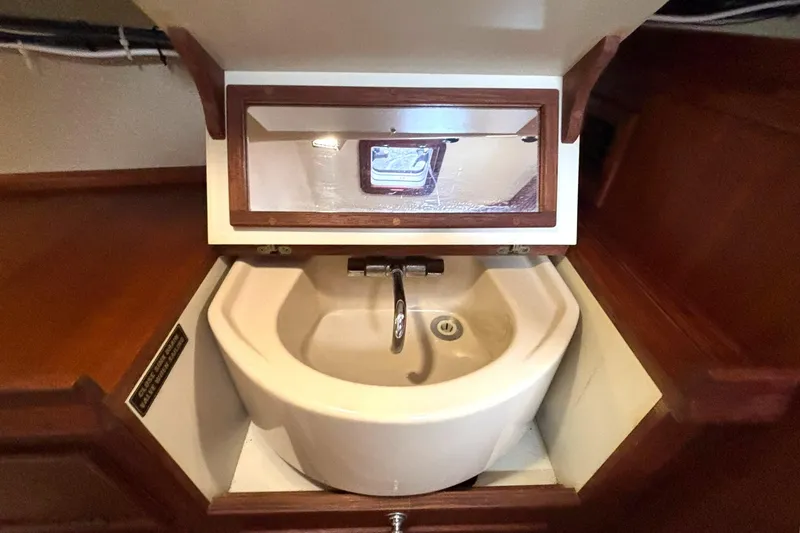 Slide: The Image of Compact sink with mirror in 2001 Island Packet 380 yacht interior. - 22