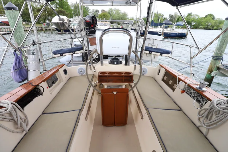 Slide: The Image of Cockpit of 2001 Island Packet 380 sailboat with steering wheel and seating. - 23