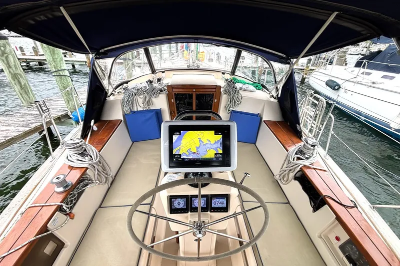 Slide: The Image of Cockpit of 2001 Island Packet 380 sailboat with navigation equipment and steering wheel. - 25