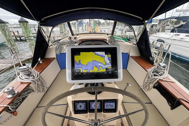 Slide: The Image of Cockpit of 2001 Island Packet 380 sailboat with navigation equipment and steering wheel. - 26