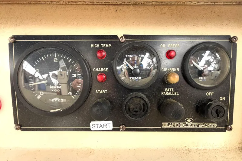 Slide: The Image of Control panel of a 2001 Island Packet 380 yacht with RPM, temperature, and oil pressure gauges. - 27