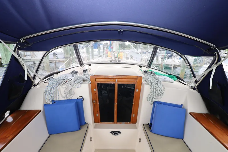 Slide: The Image of Interior view of a 2001 Island Packet 380 sailboat cockpit with blue cushions and ropes. - 28