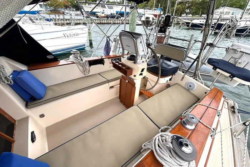 Slide: The Image of Cockpit of 2001 Island Packet 380 sailboat with seating and steering wheel. - 29