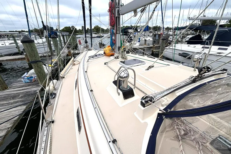 Slide: The Image of 2001 Island Packet 380 sailboat docked at a marina, showcasing deck and rigging. - 30