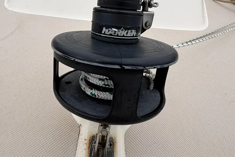 Slide: The Image of Harken winch on 2001 Island Packet 380 sailboat deck, featuring coiled rope. - 33