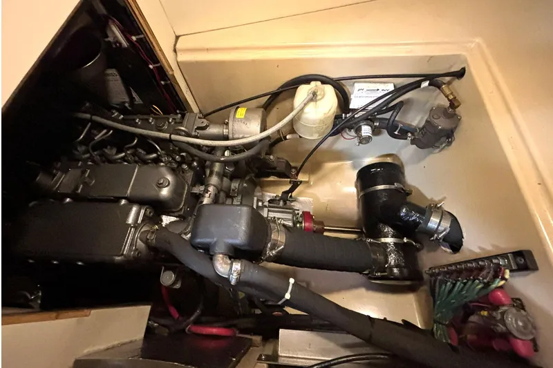 Slide: The Image of Engine compartment of a 2001 Island Packet 380 sailboat, showcasing mechanical components. - 39