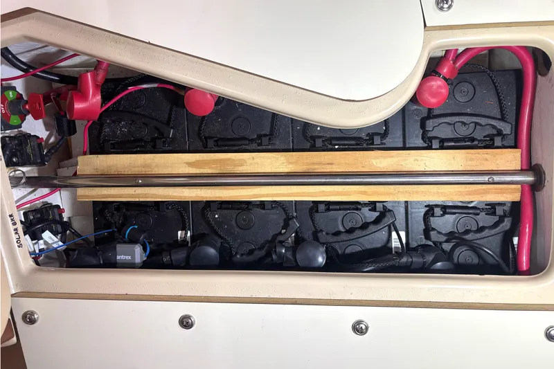 Slide: The Image of Battery compartment of a 2001 Island Packet 380 sailboat with wiring and connections. - 43