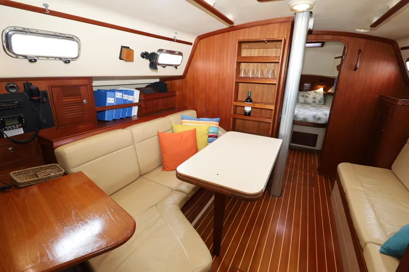Slide: The Image of Interior of 2001 Island Packet 380 sailboat with cozy seating and wooden finishes. - 5