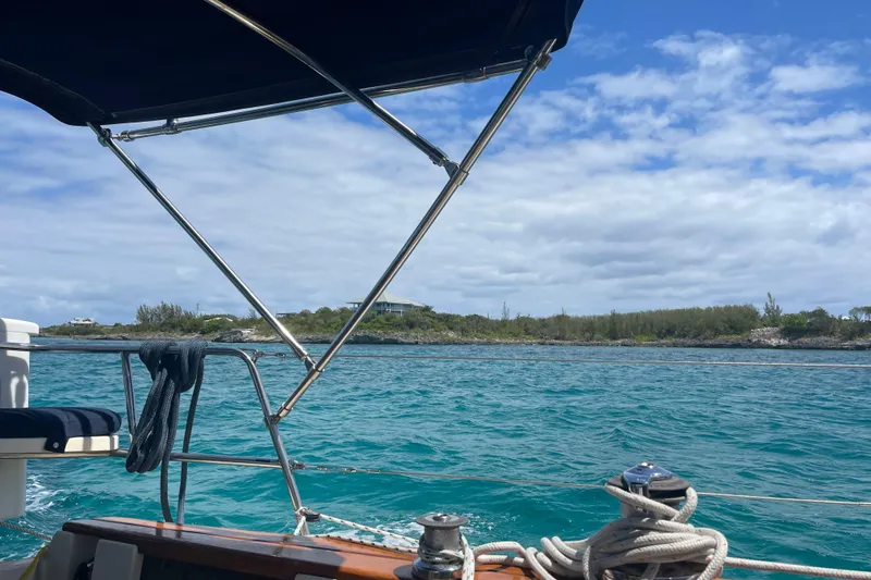 Slide: The Image of Sailing on a 2001 Island Packet 380, overlooking turquoise waters and lush shoreline. - 52