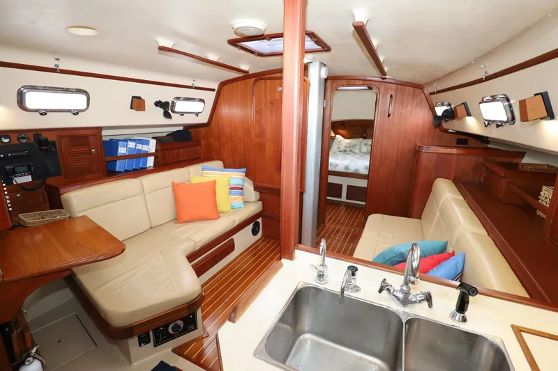 Slide: The Image of Interior of 2001 Island Packet 380 sailboat with cozy seating and colorful cushions. - 6