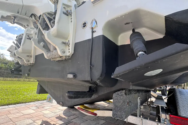 Slide: The Image of 2022 Aquasport 2500 Center Console boat on trailer, showing hull and engine details. - 17