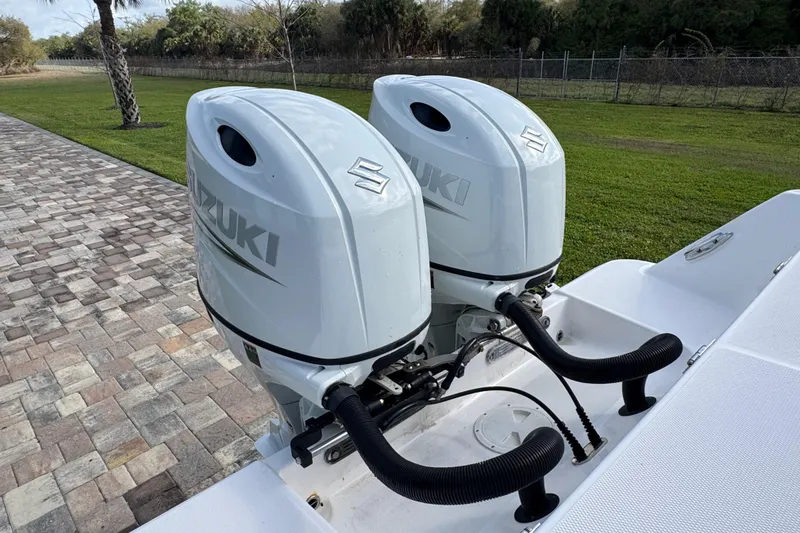 Slide: The Image of Twin Suzuki outboard engines on 2022 Aquasport 2500 Center Console boat. - 19