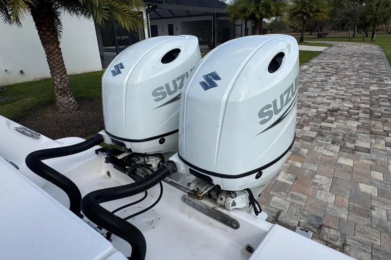 Slide: The Image of Twin Suzuki outboard engines on a 2022 Aquasport 2500 Center Console boat. - 20