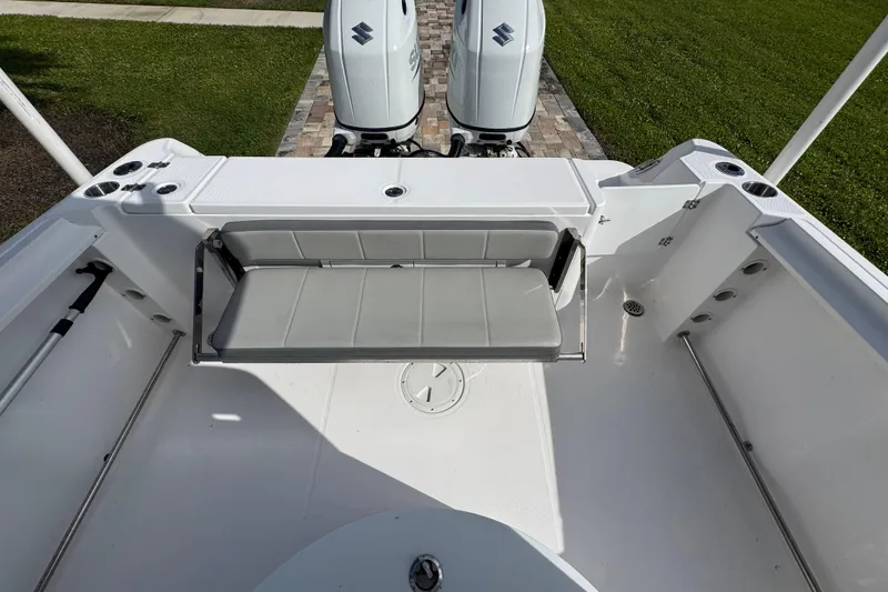 Slide: The Image of 2022 Aquasport 2500 Center Console boat with dual engines and foldable seating. - 21