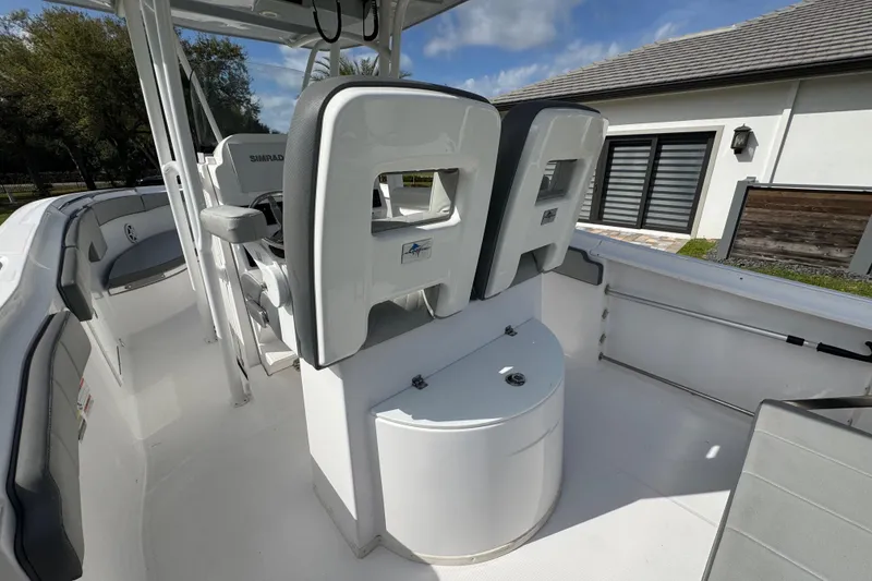 Slide: The Image of 2022 Aquasport 2500 Center Console boat interior with seating and console features. - 24