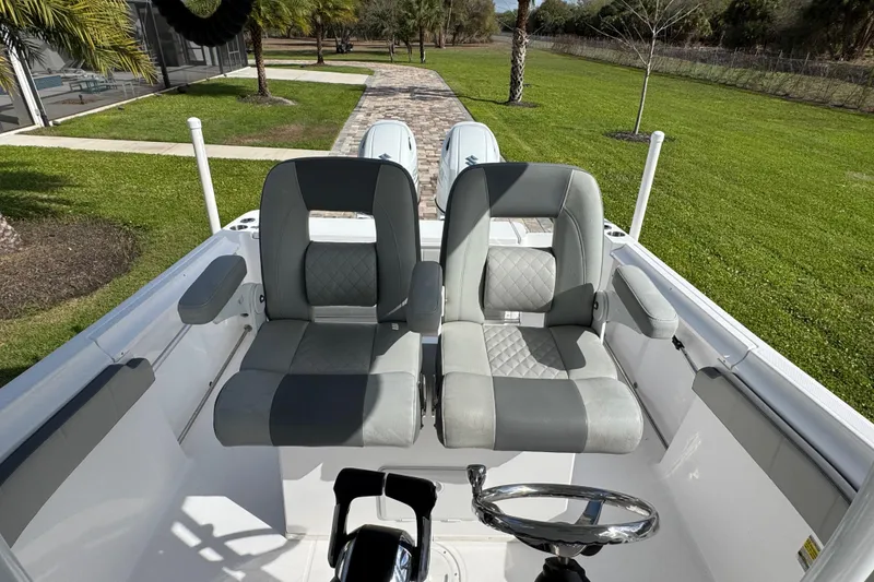 Slide: The Image of 2022 Aquasport 2500 Center Console boat with dual seats and steering wheel. - 25