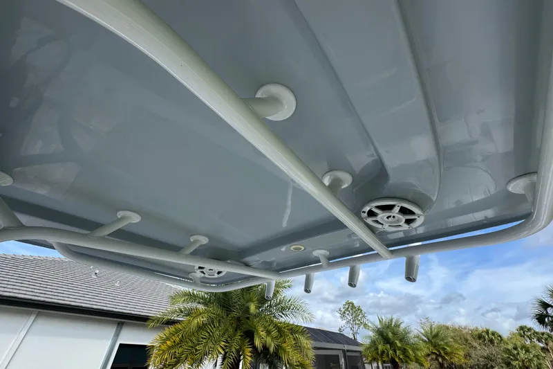 Slide: The Image of 2022 Aquasport 2500 Center Console boat roof with speakers and rod holders. - 28