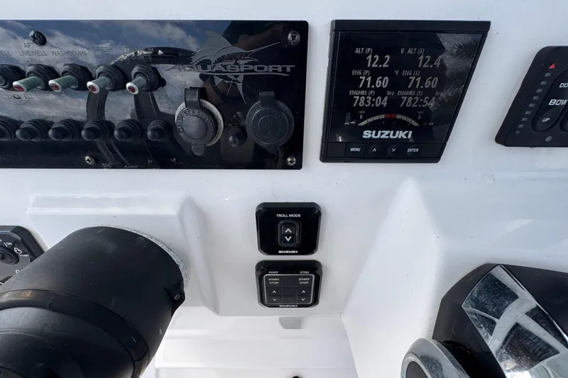 Slide: The Image of Control panel of 2022 Aquasport 2500 Center Console with Suzuki display and switches. - 34