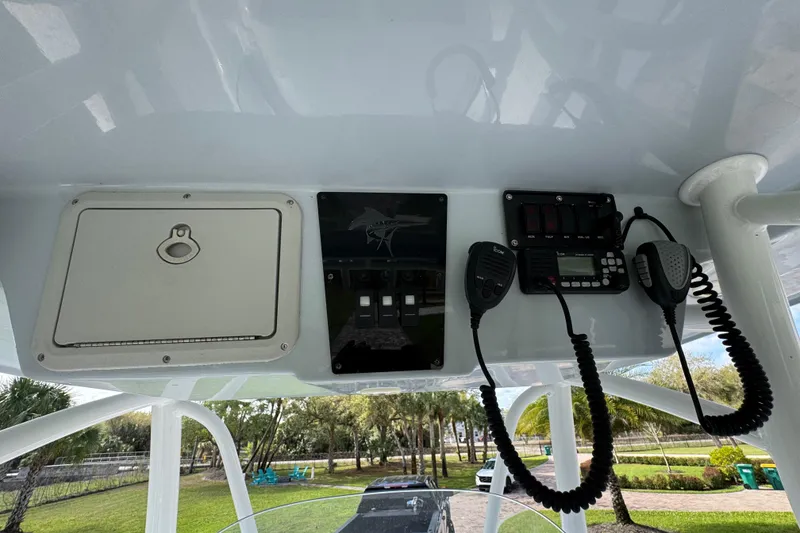 Slide: The Image of 2022 Aquasport 2500 Center Console dashboard with radio and control panel. - 35