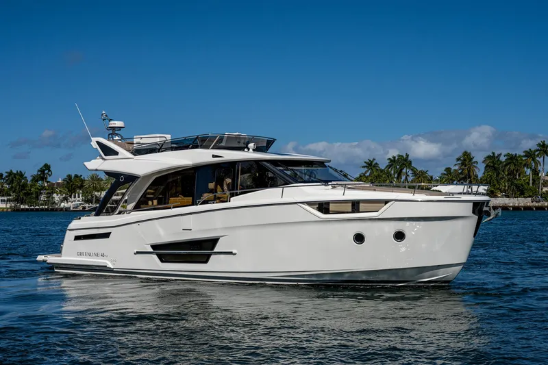 Slide: The Image of Greenline 45 Fly 2022 yacht on calm water with palm trees. - 12