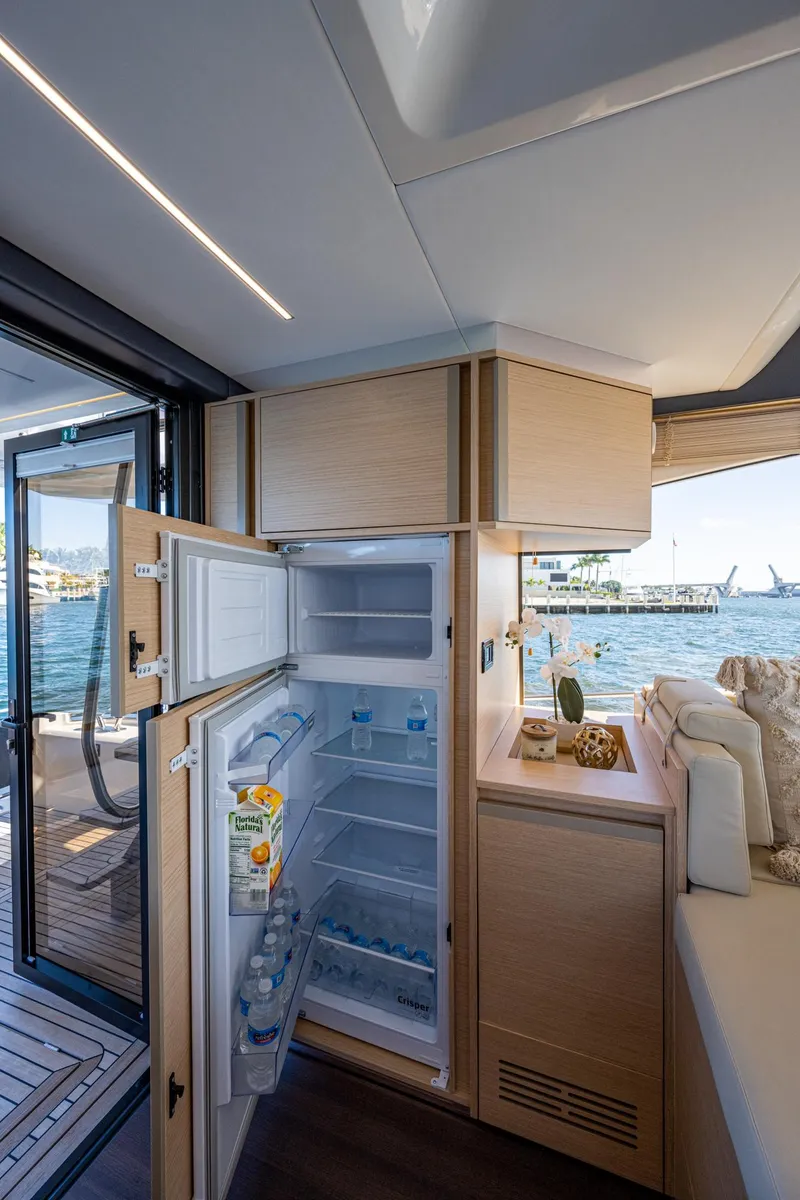 Slide: The Image of Interior of Greenline 45 Fly 2022 with open refrigerator. - 49