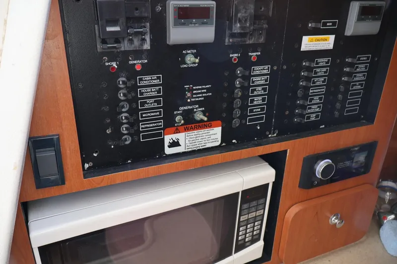 Slide: The Image of 2006 Hydra-Sports Vector 3300 VX electrical panel with microwave and control switches. - 10