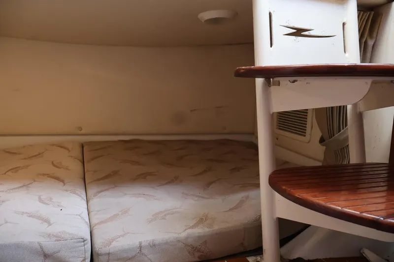 Slide: The Image of 2006 Hydra-Sports Vector 3300 VX cabin interior with cushioned seating and wooden steps. - 11