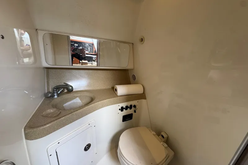 Slide: The Image of 2006 Hydra-Sports Vector 3300 VX boat bathroom with sink, mirror, and toilet. - 14