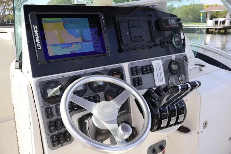 Slide: The Image of 2006 Hydra-Sports Vector 3300 VX boat dashboard with navigation system and controls. - 4