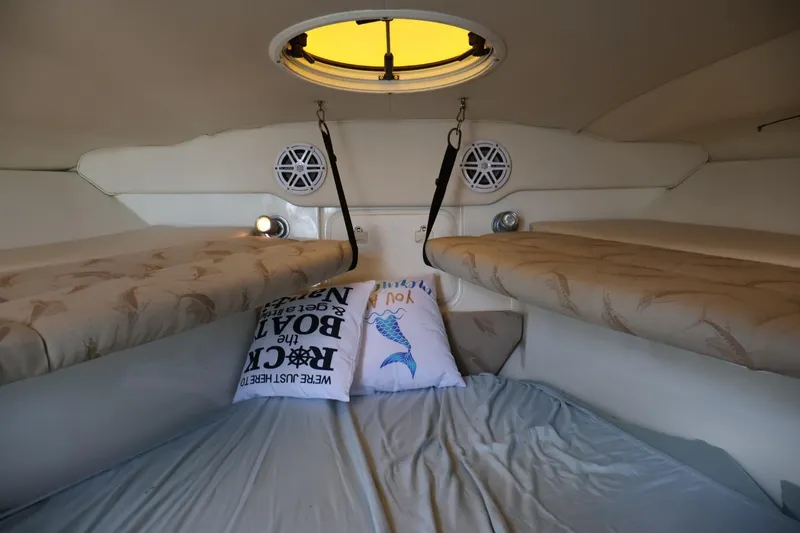 Slide: The Image of 2006 Hydra-Sports Vector 3300 VX cabin interior with cozy bedding and decorative pillows. - 8