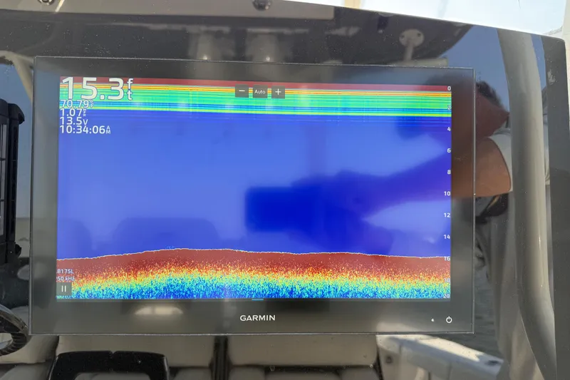 Slide: The Image of Garmin fishfinder display on 2023 Cobia 350 Center Console, showing depth and temperature. - 13
