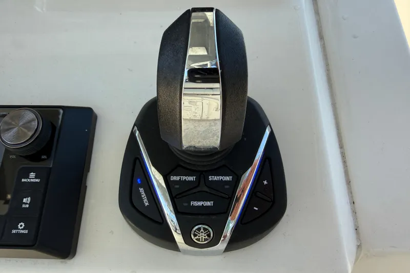 Slide: The Image of Control panel of 2023 Cobia 350 Center Console boat with joystick and settings. - 16