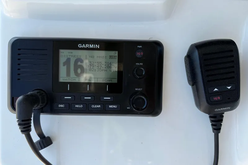 Slide: The Image of Garmin marine radio on 2023 Cobia 350 Center Console boat dashboard. - 18
