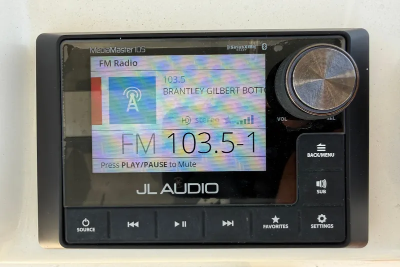 Slide: The Image of JL Audio MediaMaster display on 2023 Cobia 350 Center Console, tuned to FM 103.5. - 19
