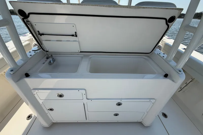 Slide: The Image of 2023 Cobia 350 Center Console boat with open storage compartment and drawers. - 24