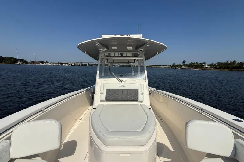 Slide: The Image of 2023 Cobia 350 Center Console boat on calm water, clear sky background. - 26