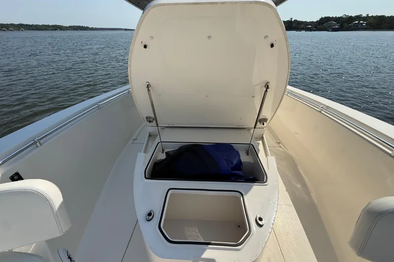 Slide: The Image of 2023 Cobia 350 Center Console boat with open storage compartment on deck. - 27