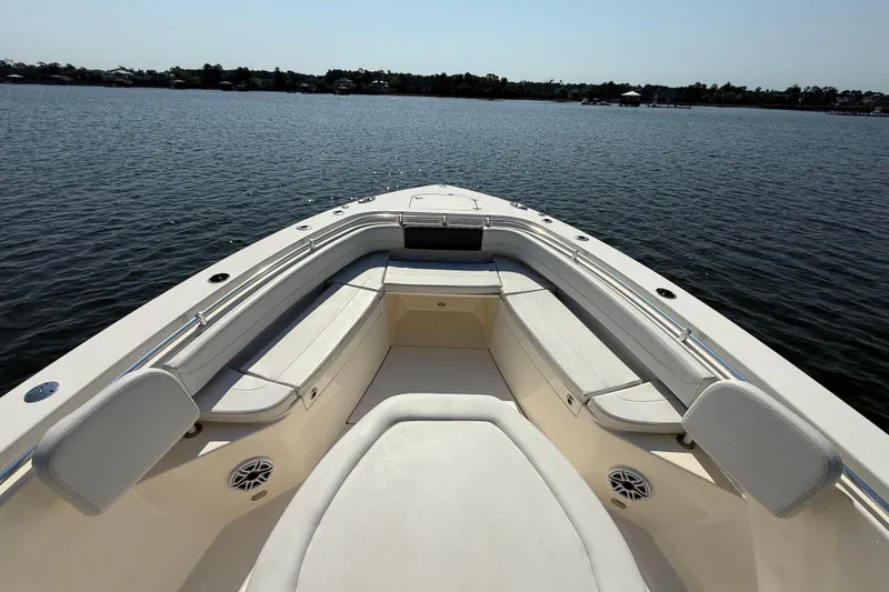 Slide: The Image of 2023 Cobia 350 Center Console boat interior with spacious seating on calm water. - 29