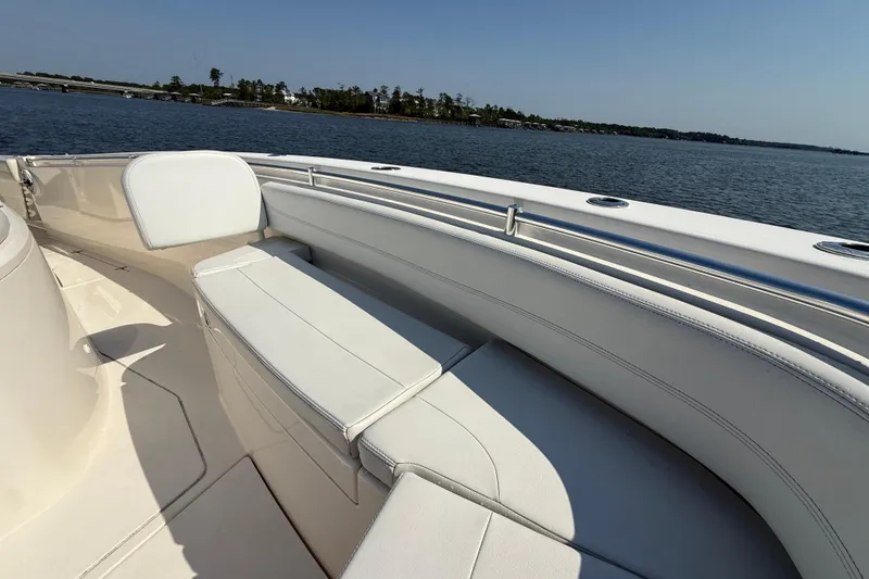 Slide: The Image of 2023 Cobia 350 Center Console boat interior with white seating, overlooking calm waters. - 30